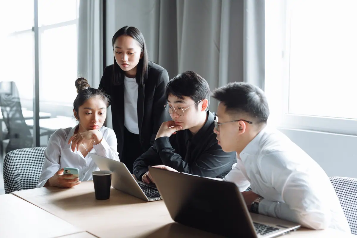 Asian people leaders collaborating in a summit breakout session