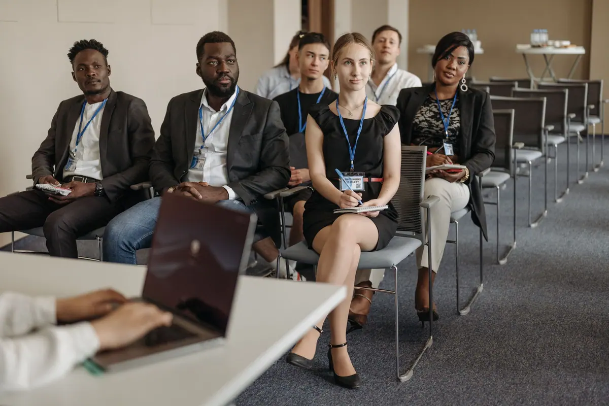 Diverse delegates engaged in a leadership summit session